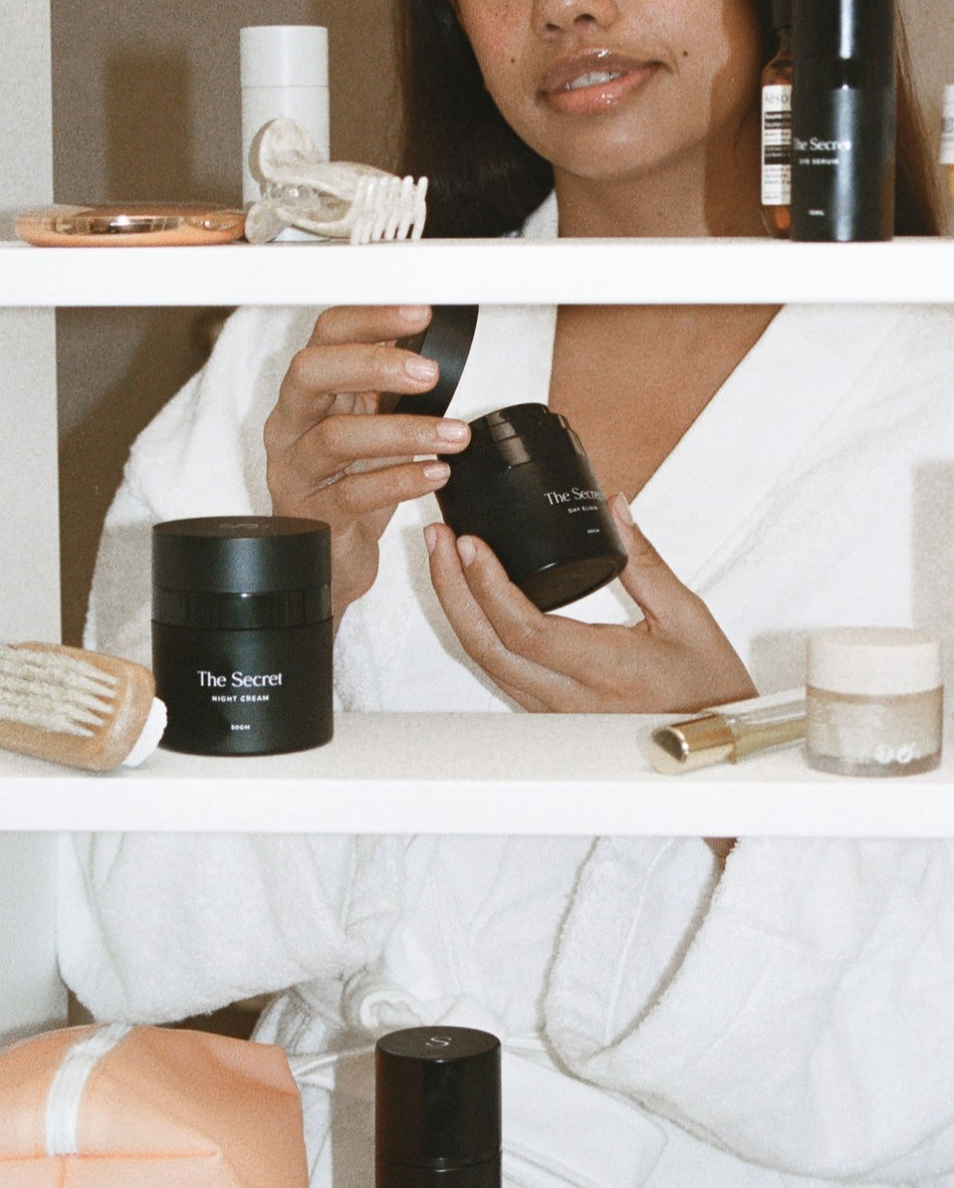young woman opening her Secret skincare product with Vitamin C to apply in the morning