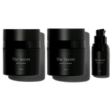 A set of three acne skincare products from The Secret brand, including a day elixir, acne night cream, and an eye product, all in black packaging.