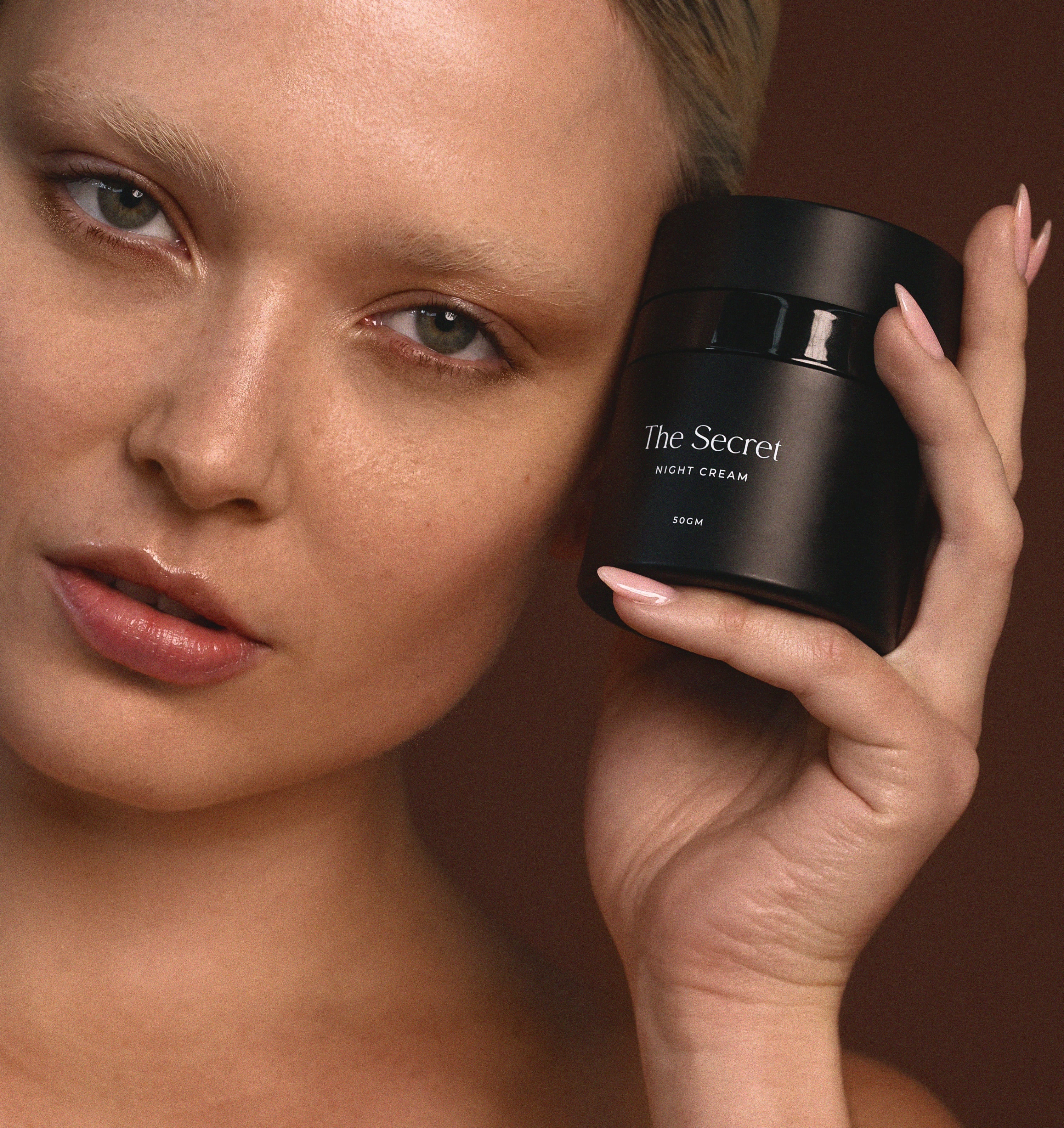 TSS Model bare-face holding the Night Cream formulation