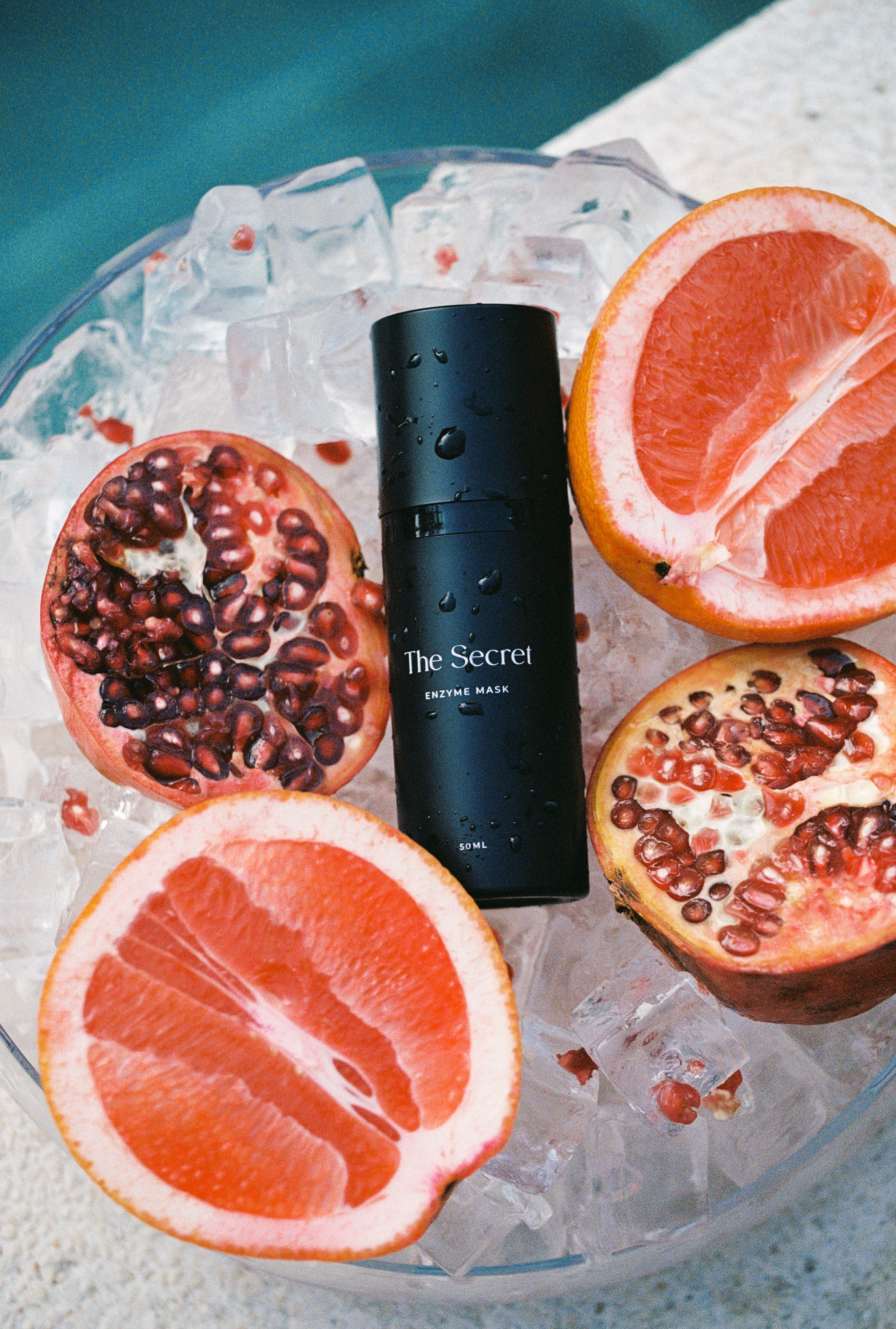 The Secret Skincare’s Enzyme Mask within a bowl of fruit highlighting the benefits of a fruit enzyme mask